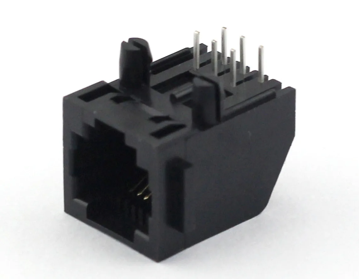 Close-up of a shielded Cat6a RJ45 patch cable terminated with a metal-shell connector, showing the latch and strain relief
